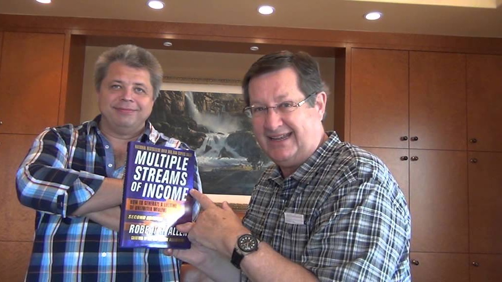 Algirdas Karalius with Robert Allen, holding Allen's book Multiple Streams of Income